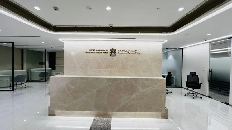 Crema marble reception wall and marble-clad desk at the Ministry of Foreign Affairs office, Festival Tower, Dubai